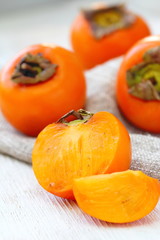 Ripe persimmon fruit on wooden table ready for eat