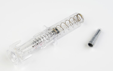 Transparent syringe with Eralfon on a white background.