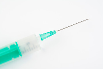 Plastic disposable syringe for injections on white background. close up.