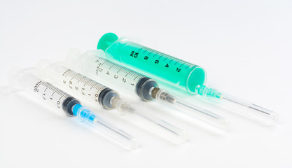 A set of disposable syringes for injections of different sizes on a white background.
