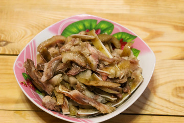 Boiled fragrant pork ears in plates on a wooden table