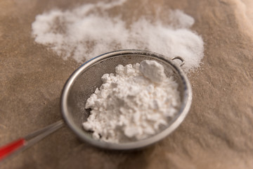 powdered sugar in a strainer