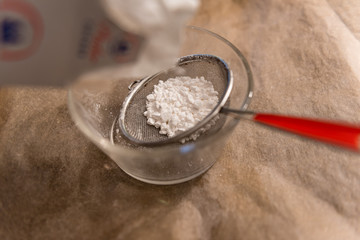 powdered sugar in a strainer