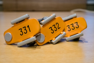 Three yellow Sauna Cabinet Locker key holders
