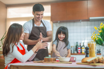 Daughter and parent preparing the bake  Family concept.