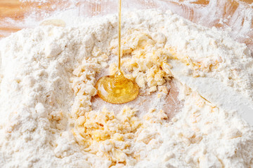 Honey, butter and flour on wooden cutting board. Making a cake.