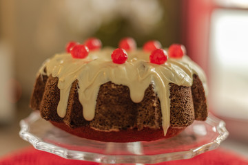 Bundt Cake with white chocolate and candied cherries.