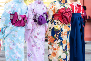 Young girl wearing Japanese kimono standing in front of Sensoji Temple in Tokyo, Japan. Kimono is a...