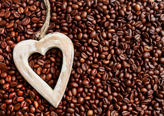 Wooden heart on coffee beans.