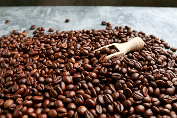 Coffee beans background and wooden scoop.