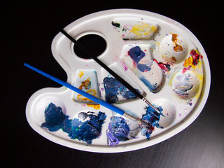 Palette with brush strokes of oil paint