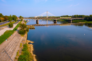 Warsaw, Poland - Panoramic view of the Vistula river with Most Srednicowy railway bridge and Powisle district of Warsaw - obrazy, fototapety, plakaty