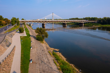 Warsaw, Poland - Panoramic view of the Vistula river with Most Srednicowy railway bridge and Powisle district of Warsaw - obrazy, fototapety, plakaty
