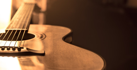 acoustic guitar close-up on a beautiful colored background - obrazy, fototapety, plakaty
