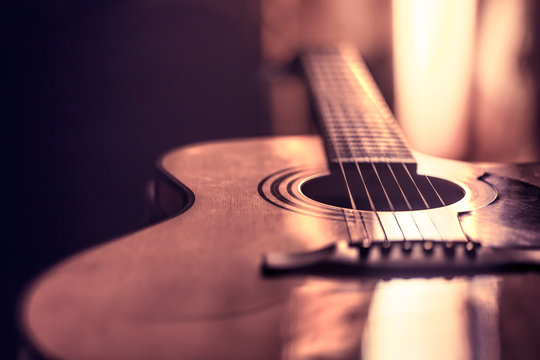 acoustic guitar close-up on a beautiful colored background