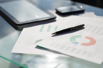 Financial paper charts and graphs on the table