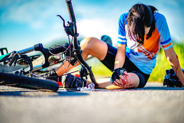 accident clashed on young woman bicyclist in hurt and injured at knee of leg and arms, after...