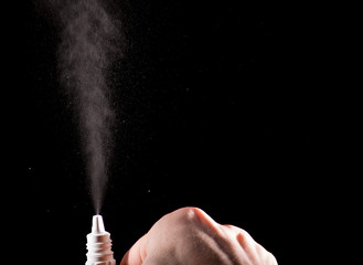 Spray for nose sprayed in the air on a black background	