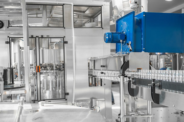 empty plastic bottles on conveyor belt. equipment at the dairy plant