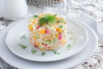 Crab salad with corn, laid out on a white plate for portion serving in a festive table setting, horizontal