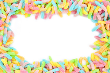 Frame of colorful gummy candies isolated on white. Top view. Space for text or design.