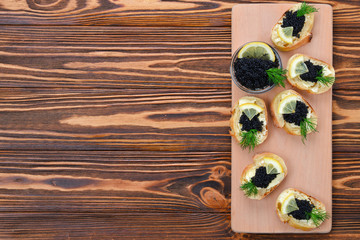Obraz na płótnie Canvas Toastes with black caviar. Spase for text or design.