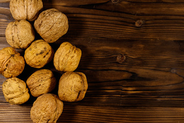 Walnuts on wooden table. Top view, copy space