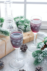 Berry liqueur on the table in the New Year's scenery, home festive drink, selective focus