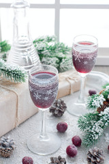Berry liqueur on the table in the New Year's scenery, home festive drink, selective focus