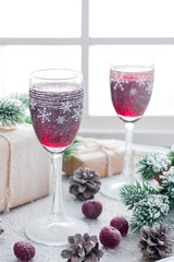 Berry liqueur on the table in the New Year's scenery, home festive drink, selective focus