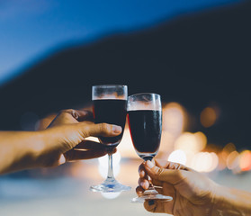 two wine glass in festive moment, light bokeh as background, vintage tone