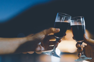 two wine glass in festive moment, light bokeh as background, vintage tone