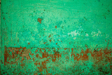 green red old concrete wall with deep scratches and damage. rough surface texture. paint and dirt stains