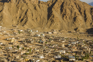 village in a deserted mountain valley. houses on the slope of sandy mountains