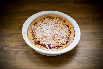 sweet cake with jam in ceramic form