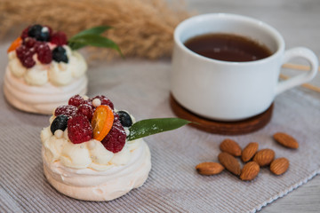 Pavlova meringue cake with cream and small fruits