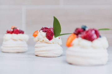 Pavlova meringue cake with cream and small fruits