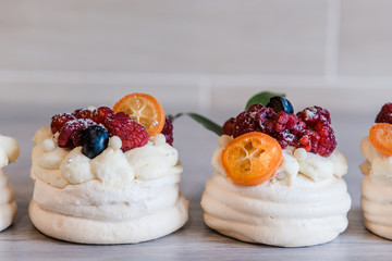 Pavlova meringue cake with cream and small fruits