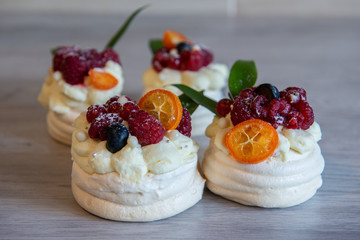 Pavlova meringue cake with cream and small fruits