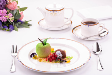 Apple dessert chocolate, branch of red currant and in flowers