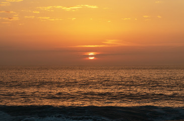 Fototapeta na wymiar Sunset time in the Atlantic ocean, Nazare, Portugal.