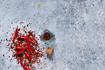 Hot chili peppers on concrete background. Advertising with space for the text. Top view