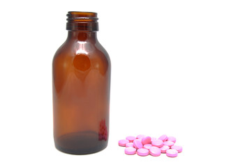 Bottle and pink pills on white background close up