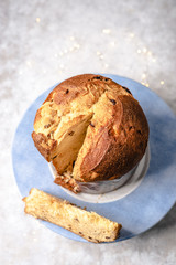 panettone: traditional Italian dessert for Christmas, sliced. Bokeh lights