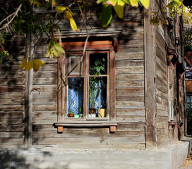 window in an old wooden house bright autumn day