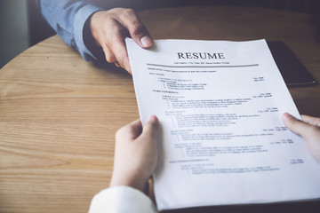 Obraz premium Applying for a job, filing a resume Experience, candidates stand the document with the company hr to get elected to work.