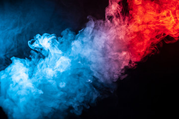 A column of colored smoke of blue and red color from a wap of an abstract form tending upwards on a...