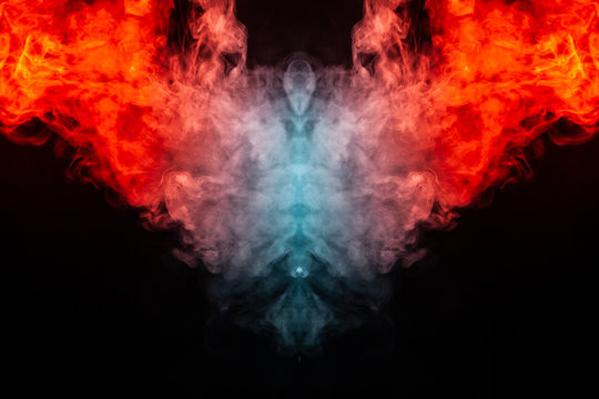 Abstract pattern of colored smoke backlit orange and red in the shape of a mystical-looking bird or a ghost-head on a black isolated background. Soul and inner state of thoughts.