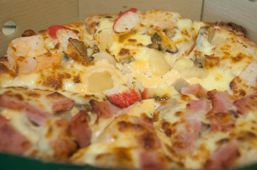 Close up of pizza ham and crab sticks