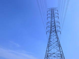 High voltage towers with sky background.